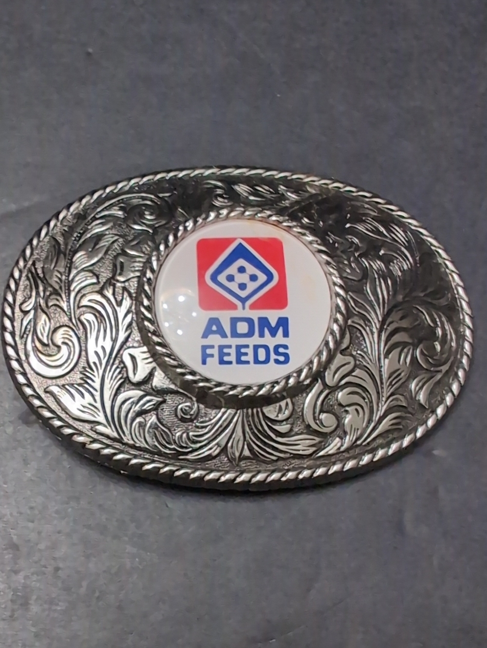 ADM Feeds Silver Toned Ornate Western Belt Buckle.